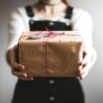 Gift Exchange - person showing brown gift box