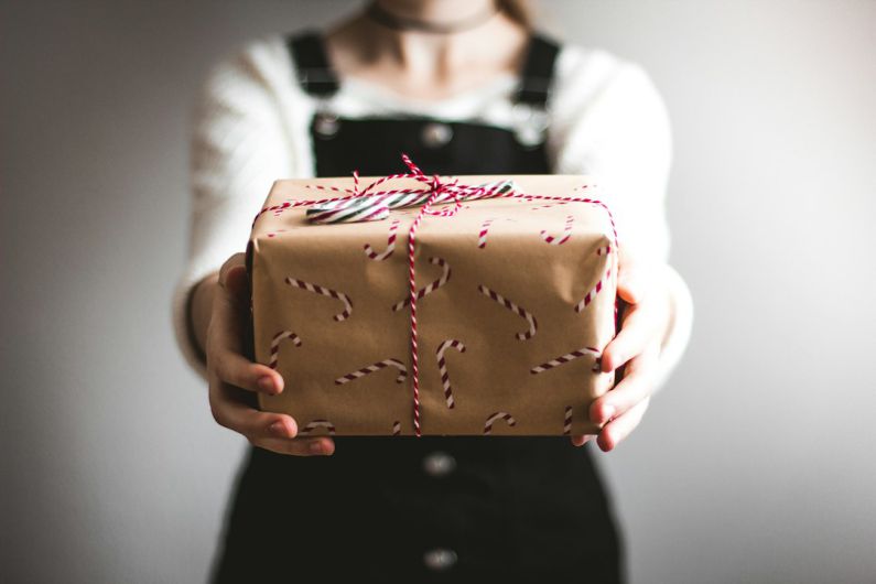 Gift Exchange - person showing brown gift box