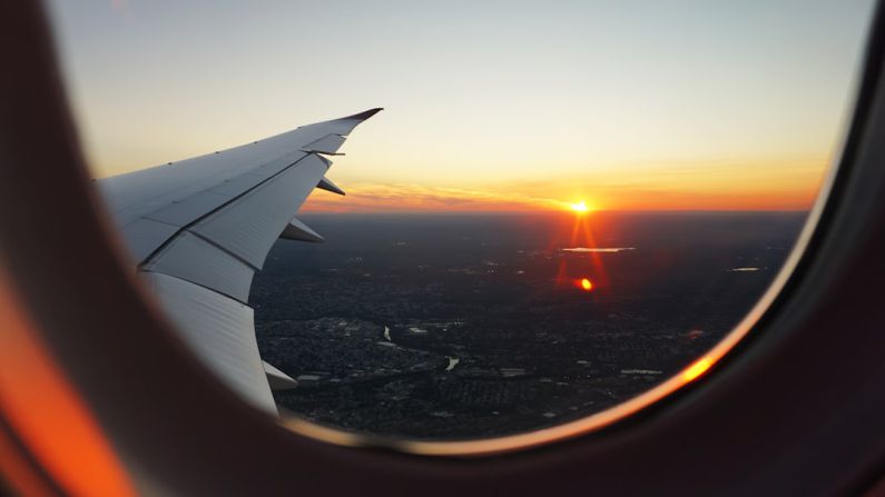 Flight Essentials - airplanes window view of sky during golden hour