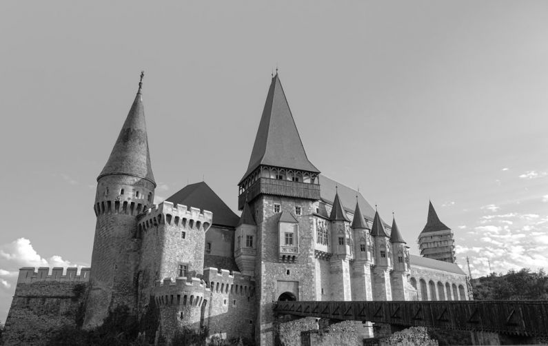 Romania Castle - a black and white photo of a castle