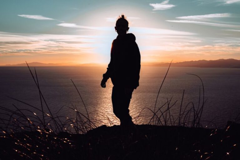 Self-discovery - silhouette of man standing on hill during sunset