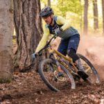 Mountain Biking - a man riding a mountain bike through a forest